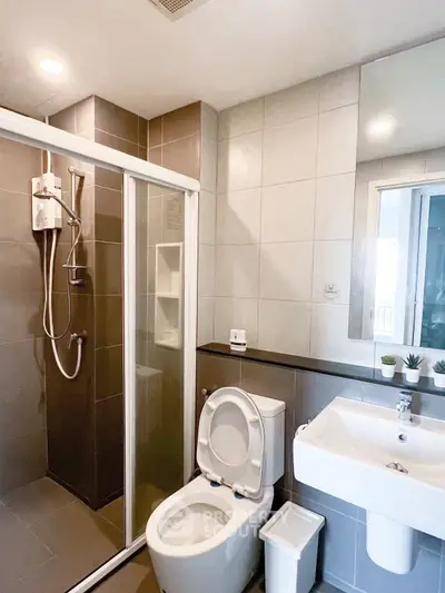 Modern bathroom with sleek shower and contemporary fixtures in stylish apartment.