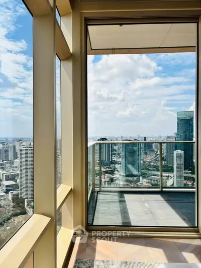 Stunning high-rise balcony with panoramic city views and modern glass railing.