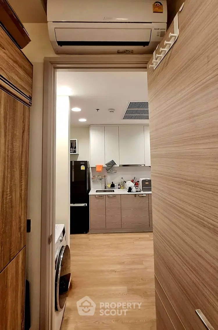 Modern kitchen with wooden cabinets and integrated appliances