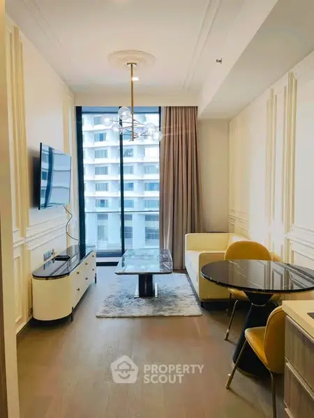 Elegant living room with modern furniture and large window view in luxury apartment.
