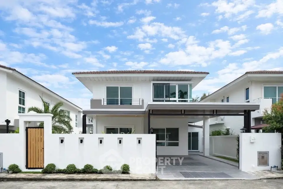 Modern two-story house with sleek design and spacious driveway in a serene neighborhood.