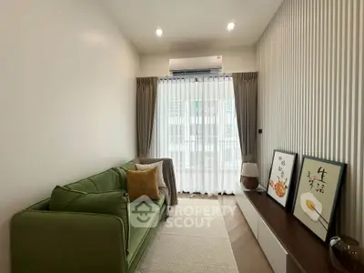 Modern living room with green sofa and stylish decor in a cozy apartment.