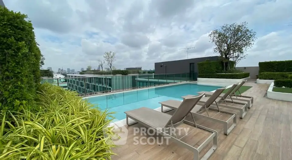 Luxurious rooftop pool with city views and modern lounge chairs, perfect for relaxation and leisure.