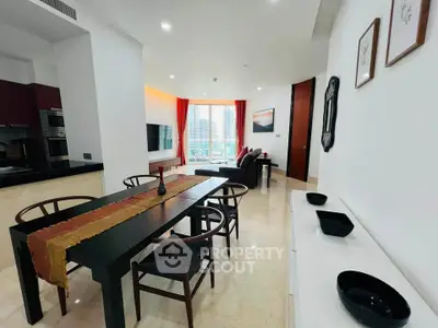 Modern open-plan living and dining area with city view, featuring sleek furniture and stylish decor.