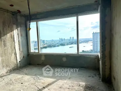 Unfinished high-rise apartment with panoramic city and river view, potential for luxury living.