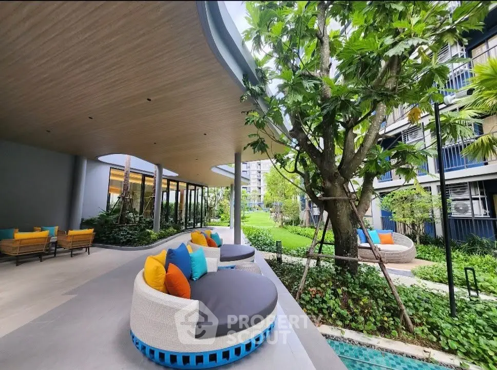 Luxurious garden view with modern outdoor seating in a stylish residential complex.