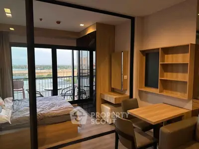Modern apartment with bedroom and balcony offering stunning city views.