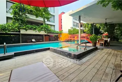 Luxurious poolside area with modern design and lush greenery