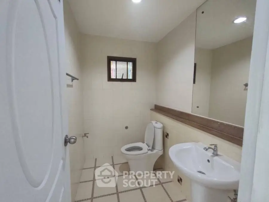 Spacious bathroom with modern fixtures and large mirror