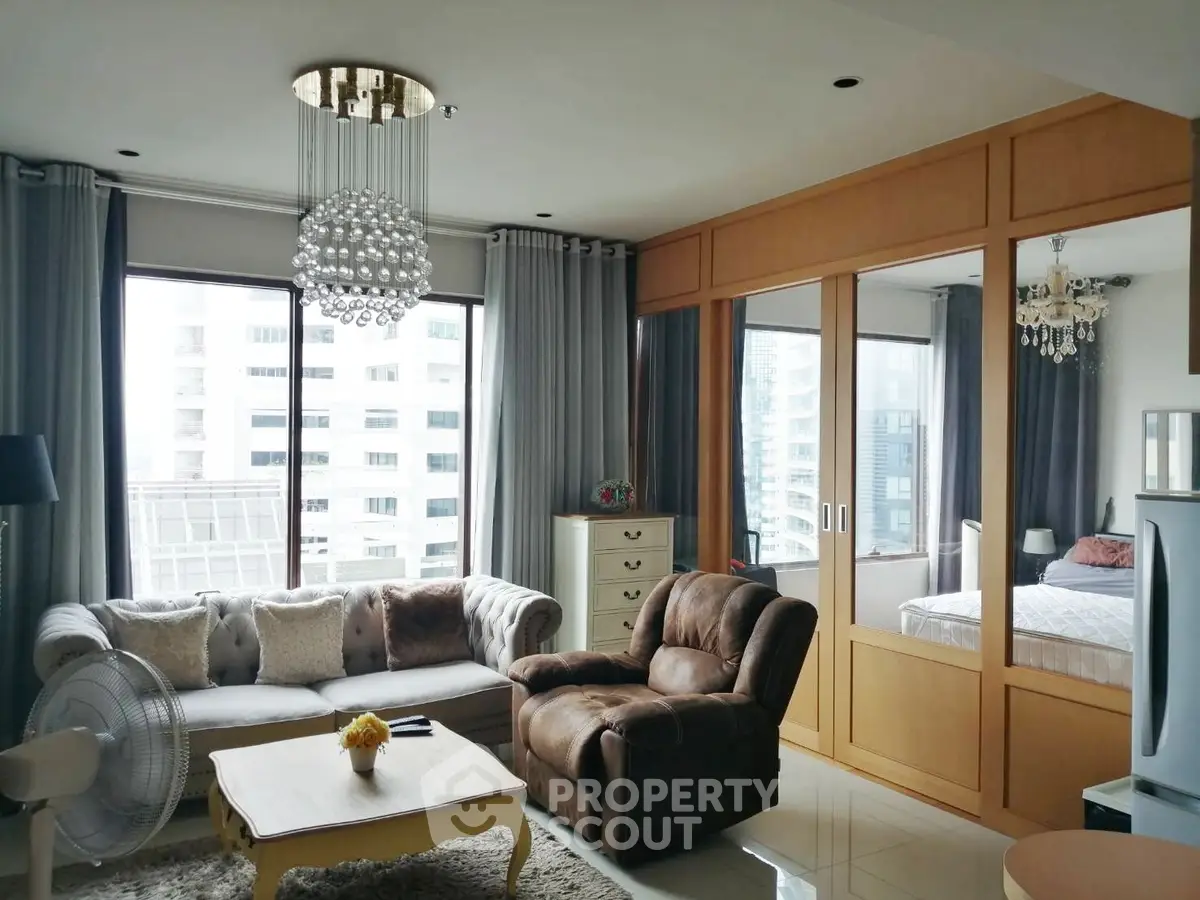 Luxurious living room with elegant decor and city view, featuring plush seating and modern lighting.
