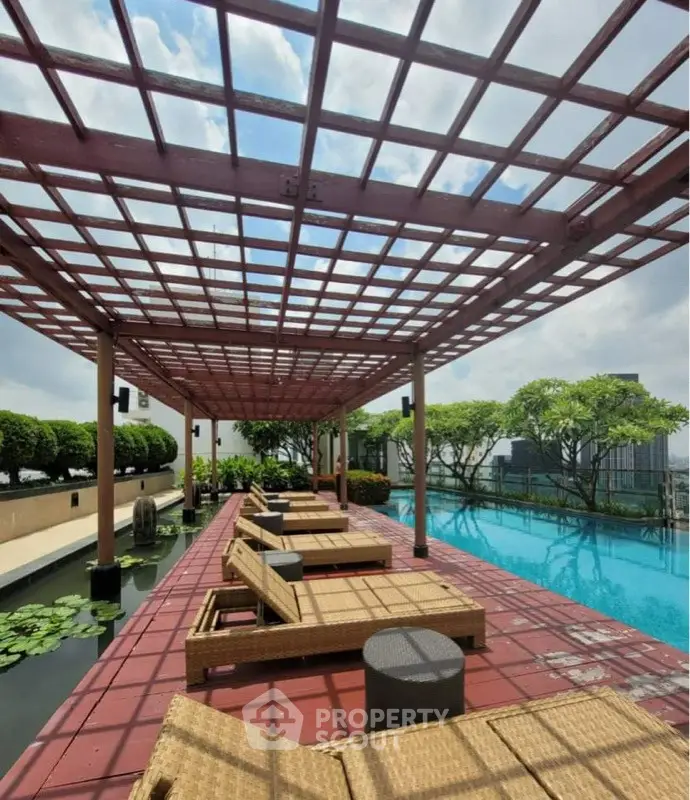 Luxurious rooftop pool with stylish lounge chairs and city views, perfect for relaxation and leisure.