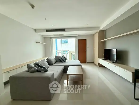 Spacious modern living room with sleek furniture and natural light