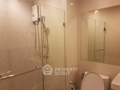 Modern bathroom with glass shower enclosure and large mirror