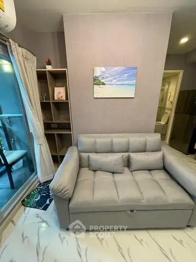 Cozy living room with modern sofa and balcony view in stylish apartment