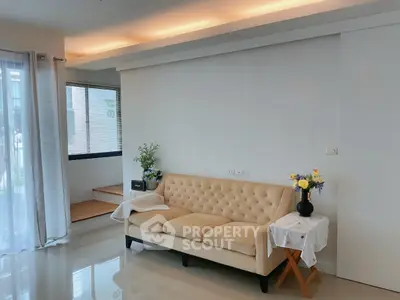 Stylish living room with cozy beige sofa and elegant decor