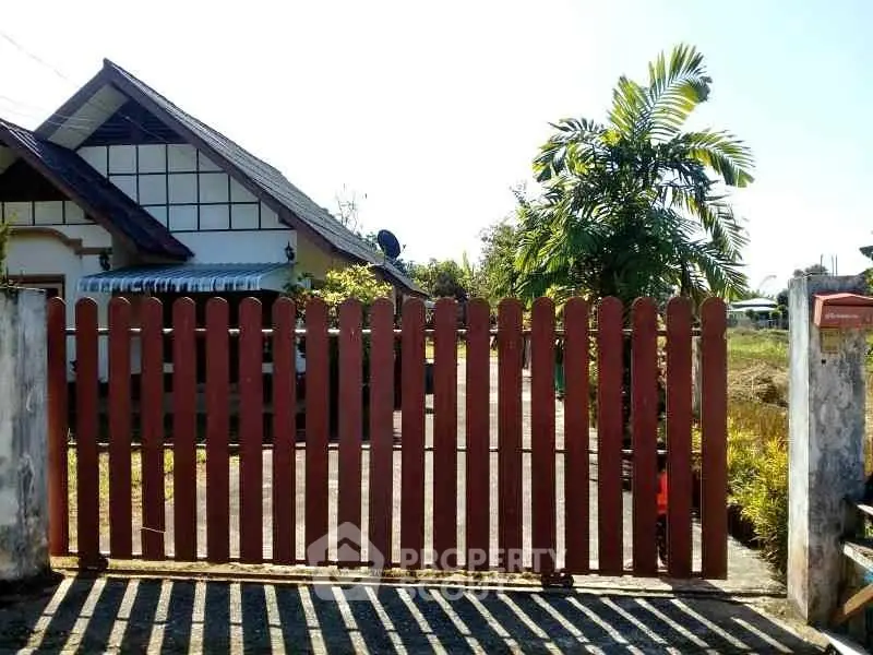 Charming suburban home with wooden gate and lush greenery, perfect for family living.