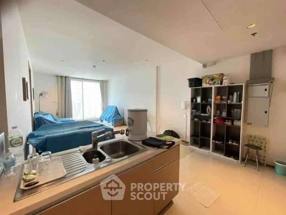 Spacious open-layout living area with modern kitchen and ample natural light.