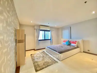 Spacious modern bedroom with large window and stylish decor
