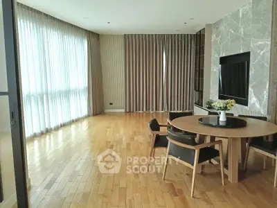 Spacious modern living room with elegant wooden flooring and stylish furniture.