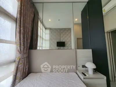 Modern bedroom with large windows, stylish curtains, and sleek decor.