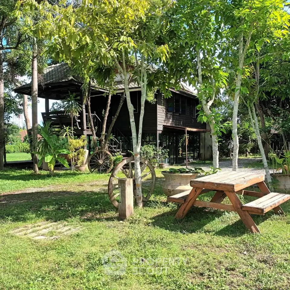 Charming rustic wooden house with lush garden and picnic area, perfect for serene countryside living.