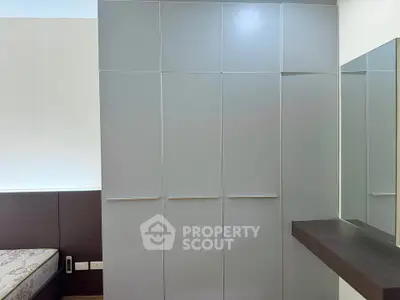 Modern bedroom with sleek wardrobe and stylish mirror