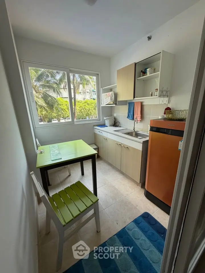 Charming kitchen with vibrant decor and natural light, featuring a cozy dining area and modern appliances.