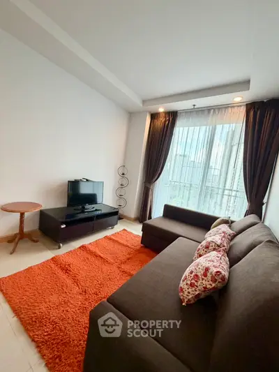 Cozy living room with modern sofa and city view, perfect for relaxation.