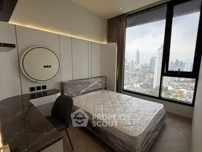 Modern bedroom with city view, featuring a stylish bed and sleek furniture, perfect for urban living.