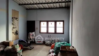 Spacious storage room with natural light and organized boxes, ideal for versatile use.