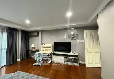 Spacious living room with modern decor and wooden flooring