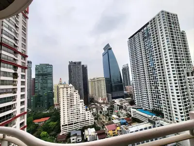 Stunning cityscape view from a high-rise balcony showcasing modern skyscrapers and urban living.