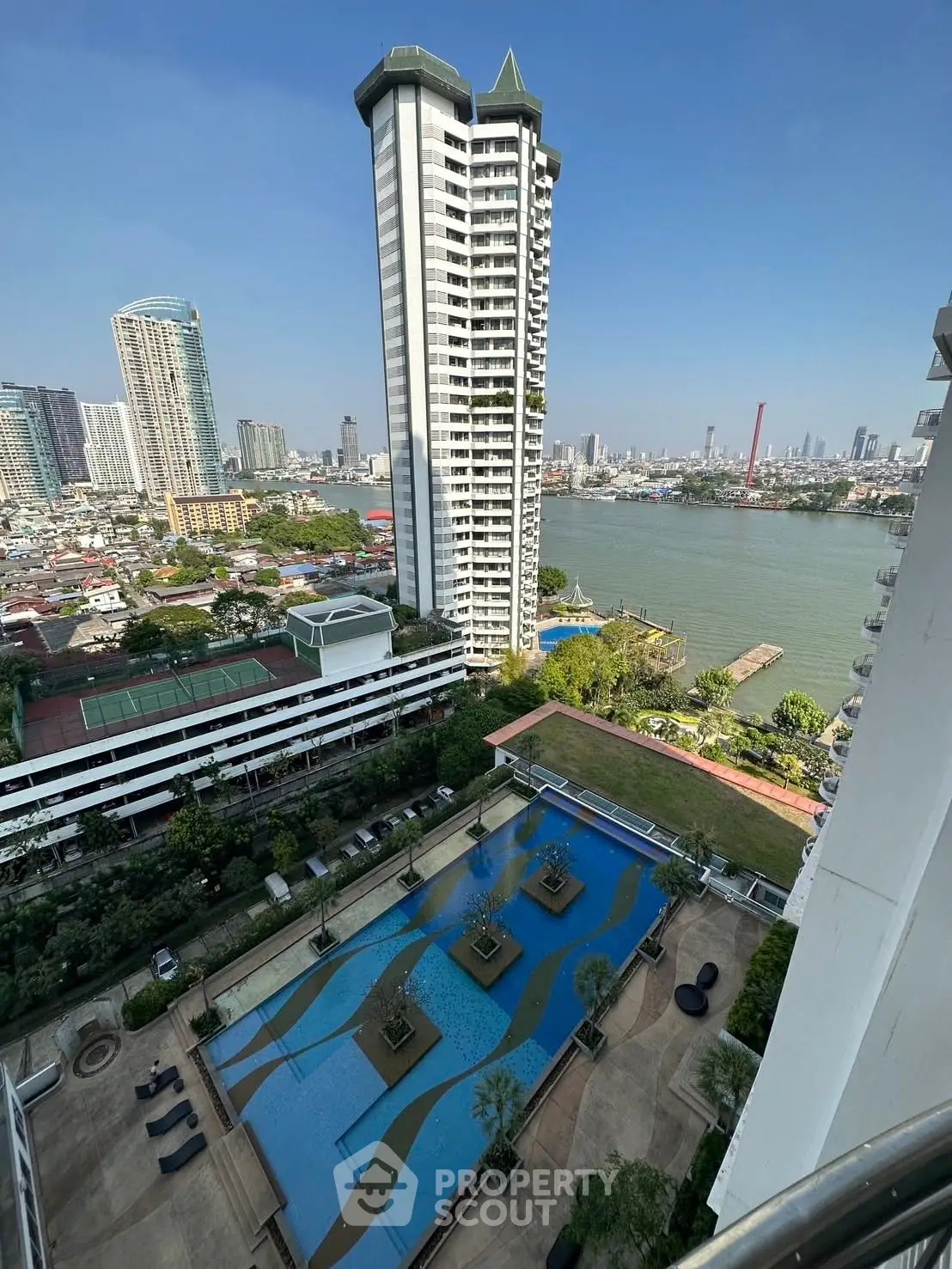 Stunning high-rise river view with pool and cityscape, perfect for luxury living.