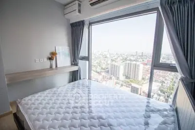 Modern bedroom with large window offering stunning city view, featuring a comfortable bed and stylish decor.