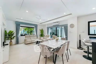 Spacious modern living room with elegant dining area and large windows
