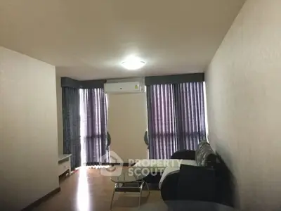 Spacious living room with modern furniture and large windows for natural light.