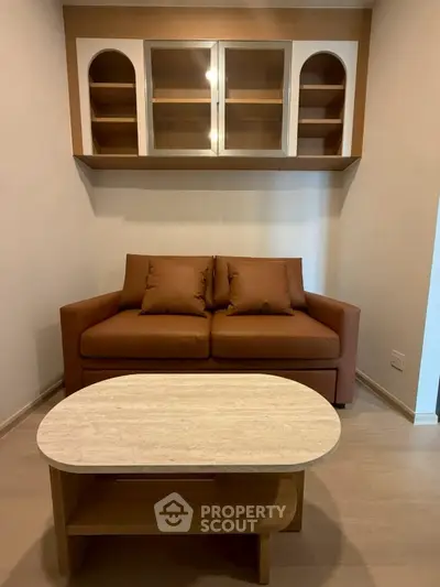 Cozy living room with modern brown sofa and stylish wooden coffee table.