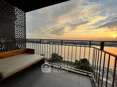 Stunning balcony with breathtaking river view at sunset, perfect for relaxation and enjoying nature.