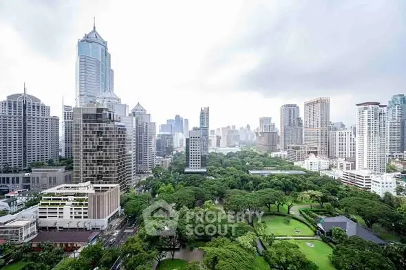 Stunning cityscape view with lush green park and modern skyscrapers.