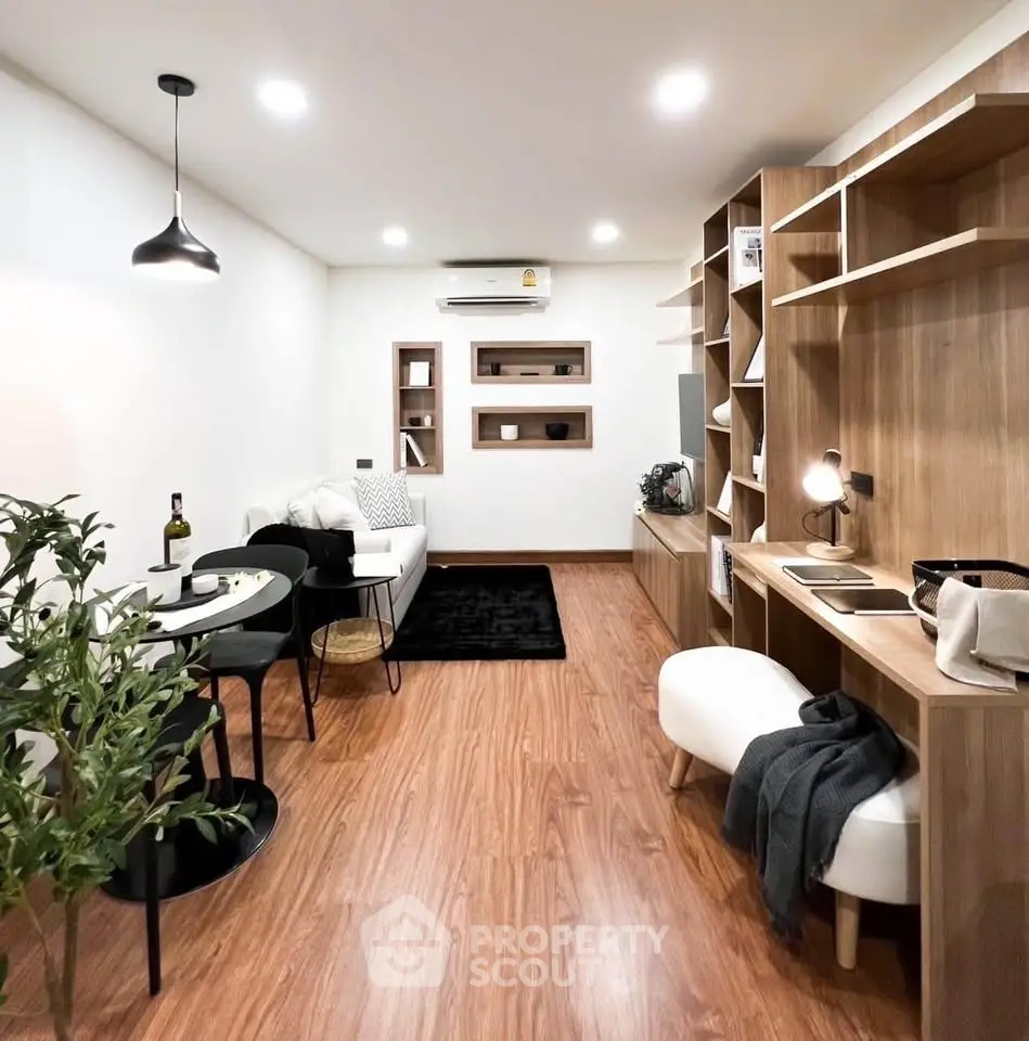 Modern living room with stylish decor, wooden flooring, and cozy seating area, perfect for relaxation and entertainment.