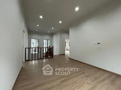 Spacious modern interior with wooden flooring and elegant lighting