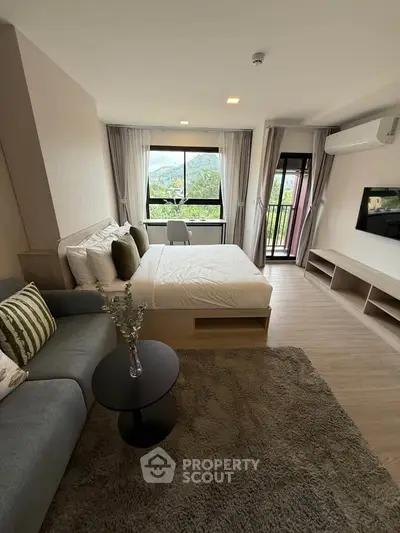 Modern bedroom with scenic view and cozy decor in a stylish apartment.