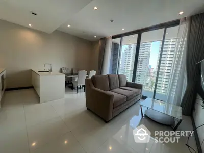 Modern open-plan living room with kitchen and city view balcony