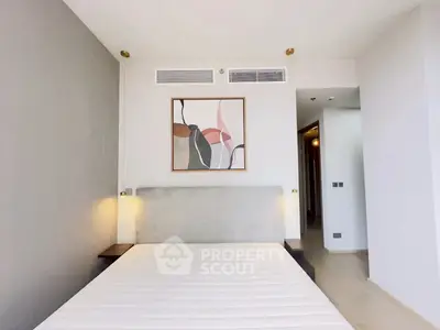 Modern bedroom with stylish decor and elegant lighting in a contemporary apartment.