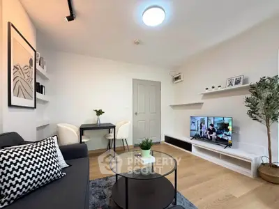 Modern living room with stylish decor, cozy seating, and a flat-screen TV, perfect for relaxation and entertainment.