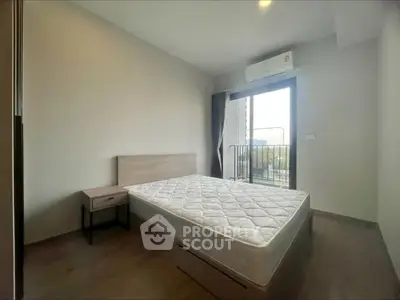 Modern bedroom with balcony access and natural light