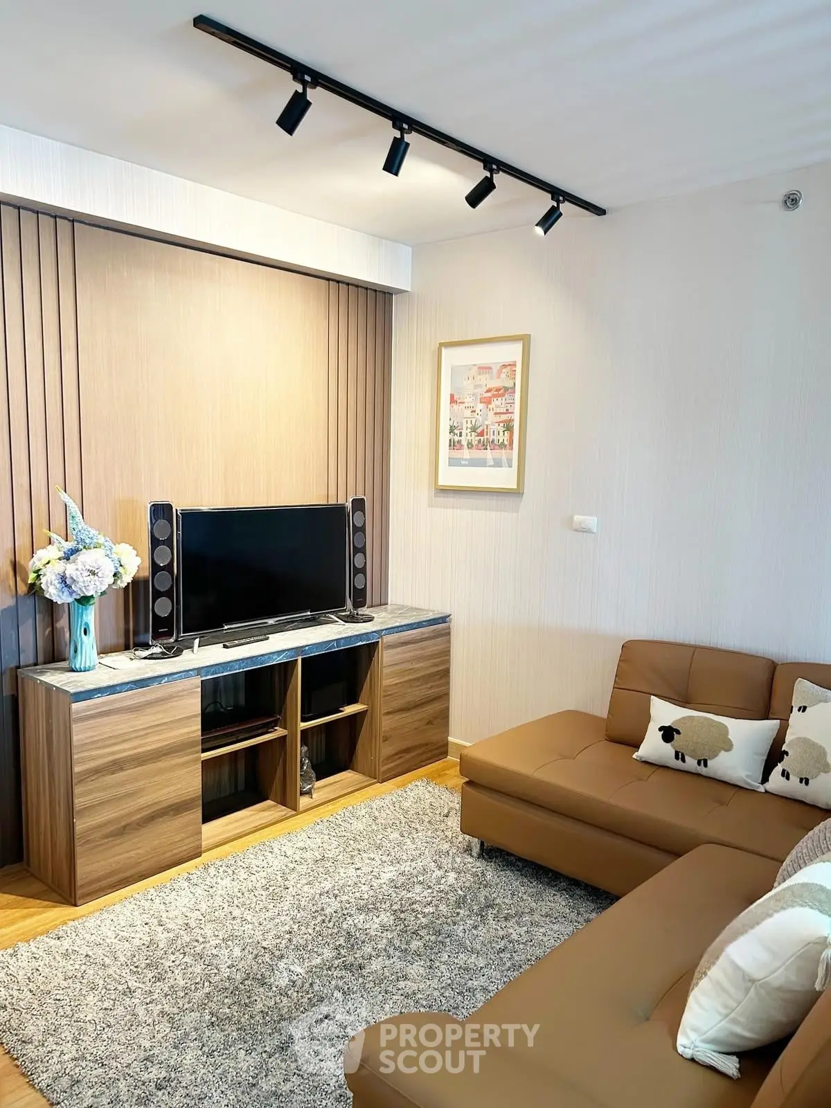 Modern living room with cozy brown sofa and stylish entertainment center