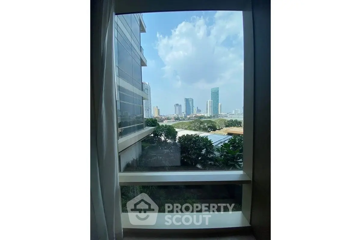 Stunning cityscape view from a modern apartment window, showcasing urban skyline and lush greenery.