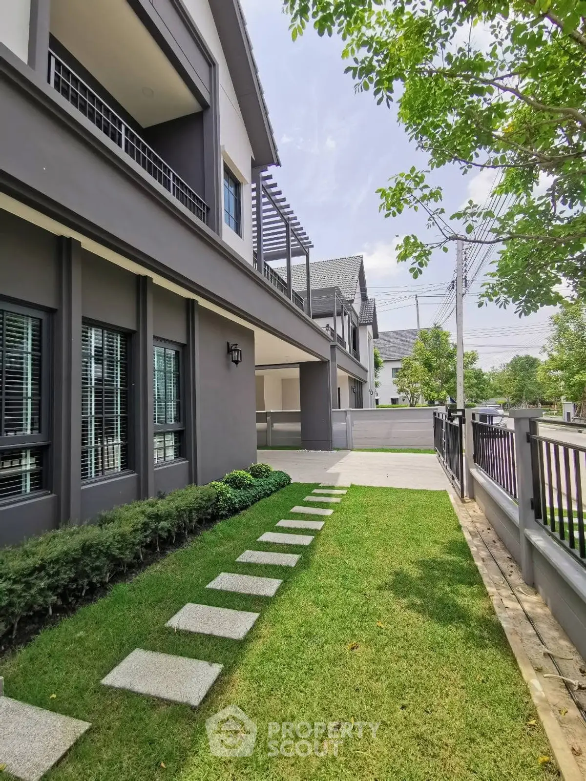 Modern two-story house with landscaped garden and pathway