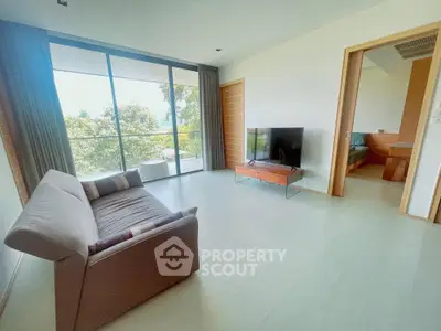 Spacious living room with modern decor and large window offering a scenic view.